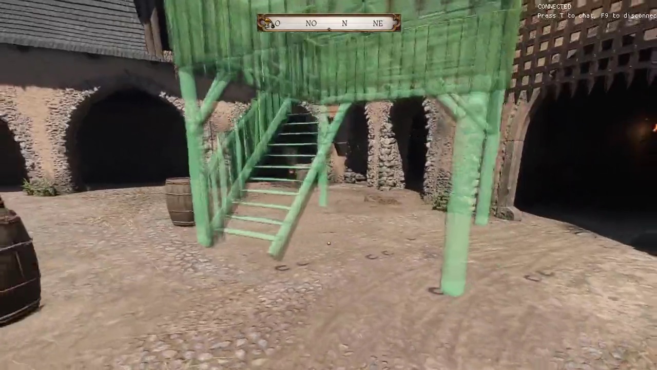 A green preview of a wooden watchtower being placed in a castle yard with build mode in Kingdoms Connected