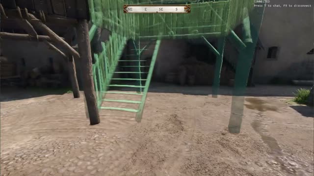 A green preview of a wooden watchtower being placed in a castle yard with build mode in Kingdoms Connected