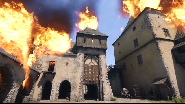 Flames placed with the map editor rising over a castle gatehouse and keep in Kingdoms Connected