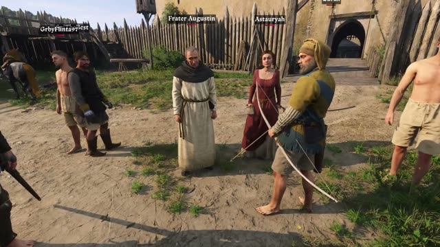 A group of players with name tags gathered at the gate of a wooden palisade fort in Kingdoms Connected