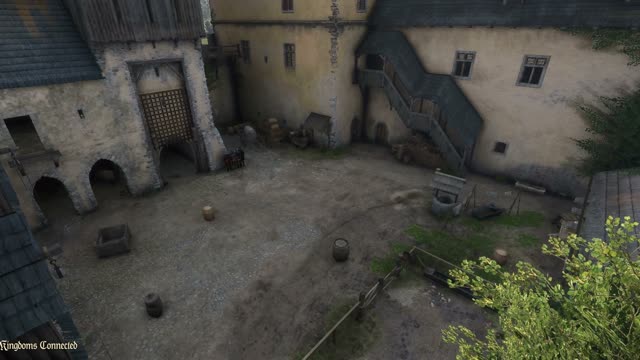 A castle courtyard seen from above with barrels and crates where players hide as props in Kingdoms Connected
