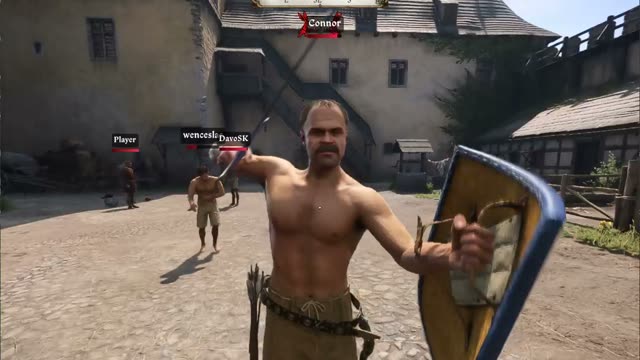 A shirtless player with a shield and a sword facing the camera in a castle courtyard in Kingdoms Connected