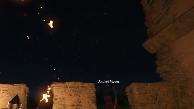 Burning trebuchet shots falling on torch-lit castle battlements at night in Kingdoms Connected